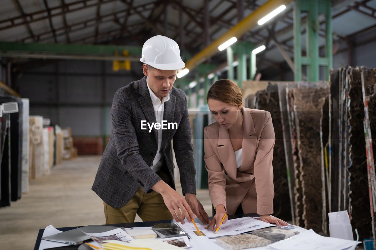 Elegant colleagues working in warehouse