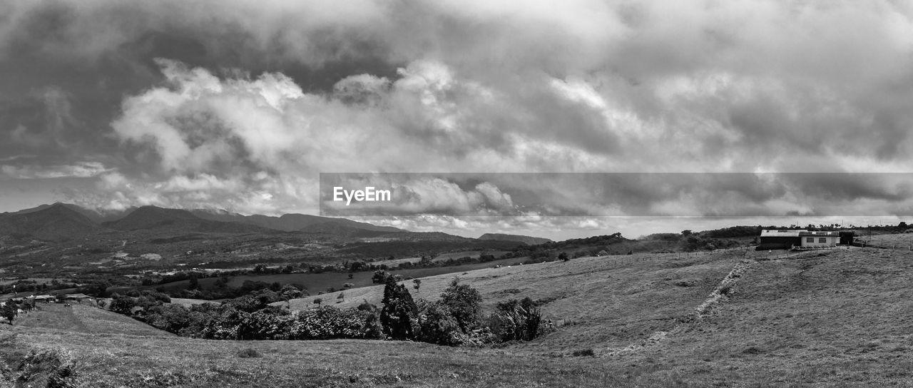 Scenic view of mountains against cloudy sky