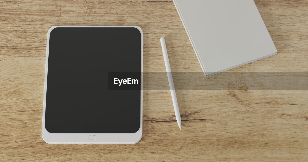 HIGH ANGLE VIEW OF MOBILE PHONE AND TABLE