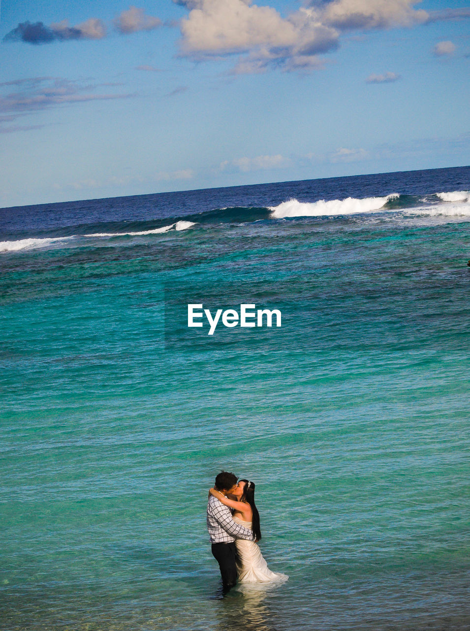 MAN IN SEA AGAINST SKY