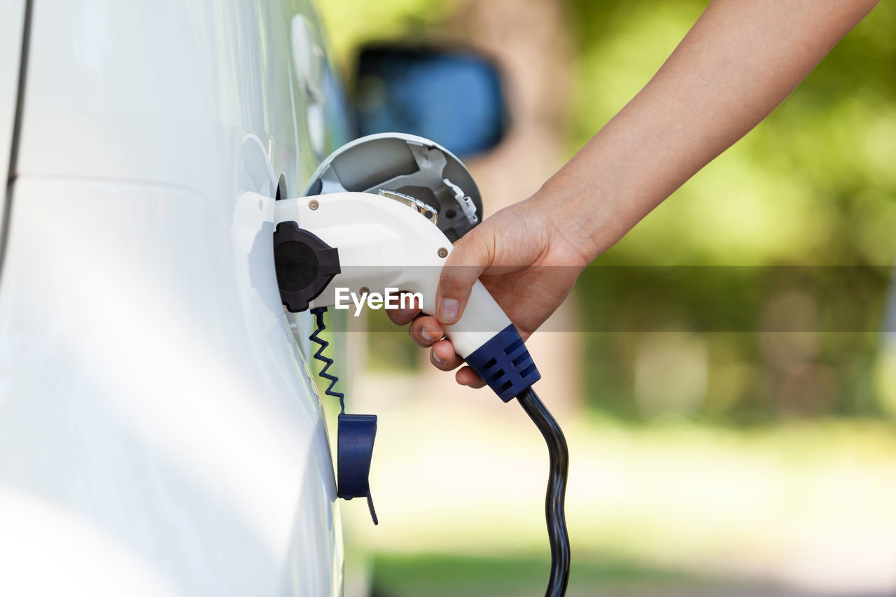 Electric car battery charging at charge station in the nature