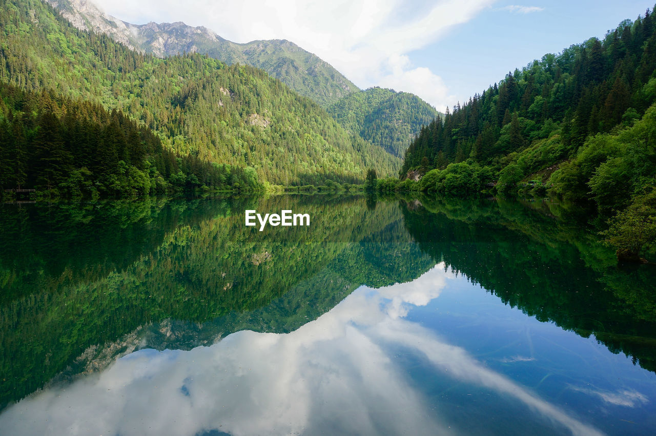 Scenic view of lake and mountains against sky