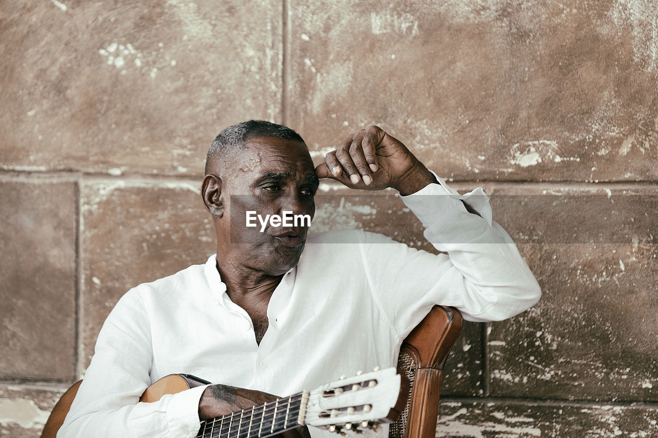 Cuban musician playing with his group in the streets of havana, cuba