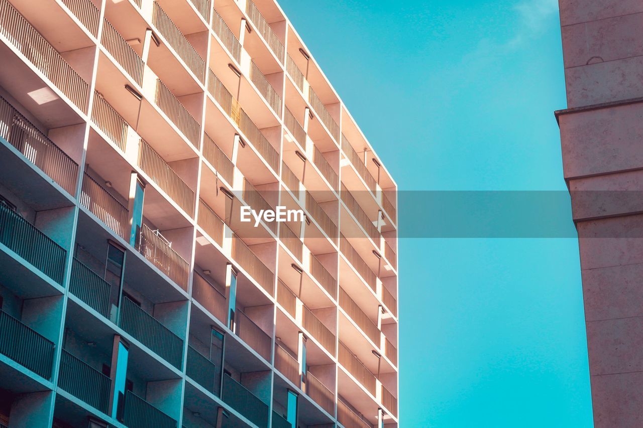 LOW ANGLE VIEW OF BUILDING AGAINST BLUE SKY