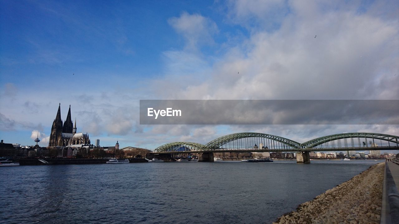 Bridge over river with buildings in background