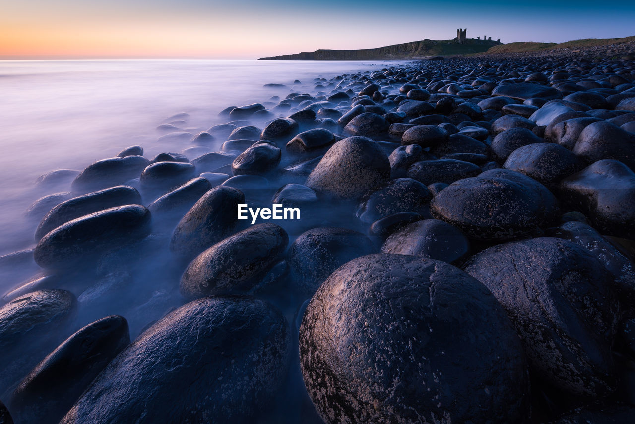 Scenic view of dunstanburgh castle during sunrise