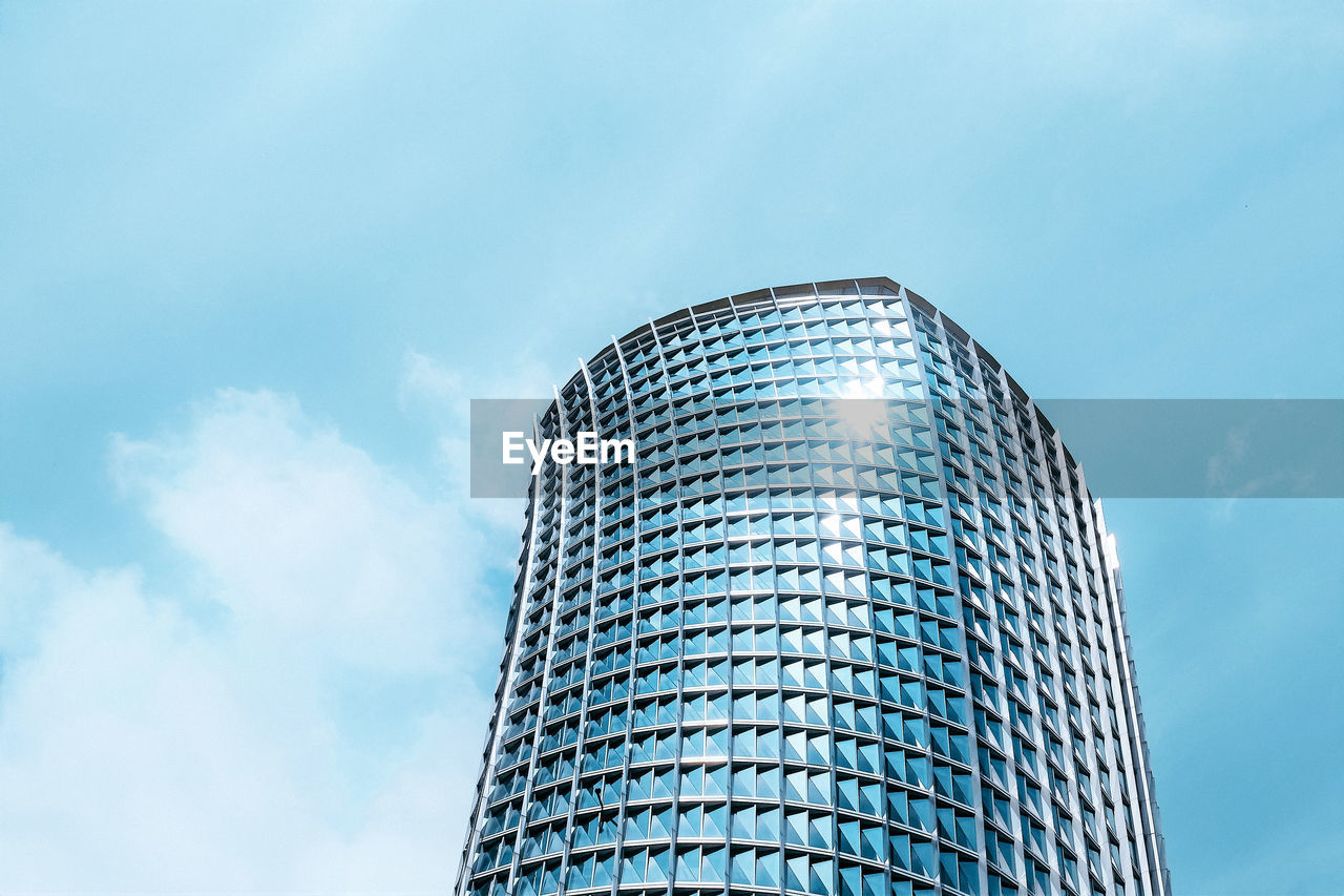 Low angle view of modern office building against sky