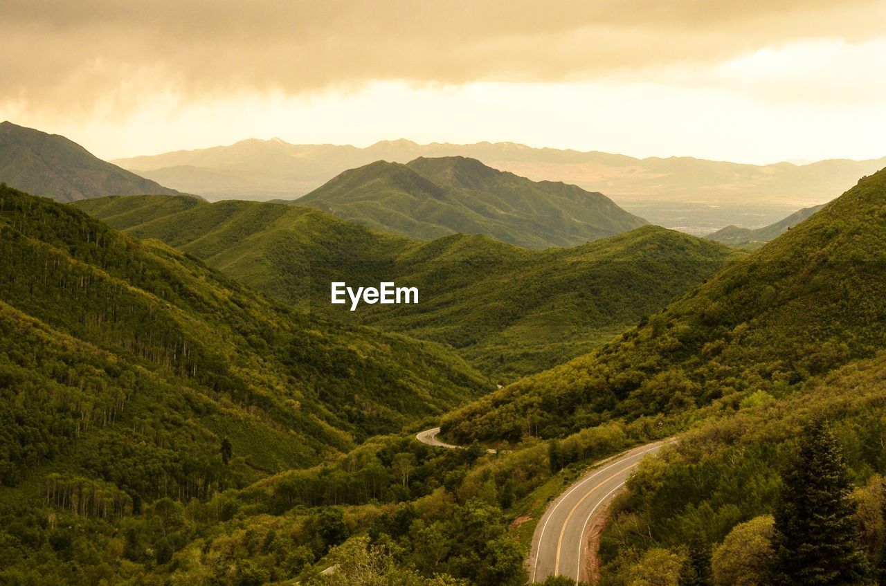 Scenic view of valley and mountains against sky