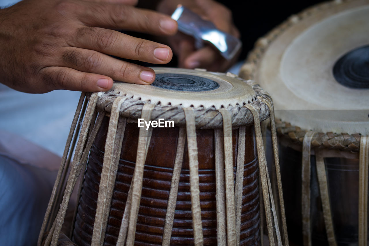 Midsection of man playing tabla