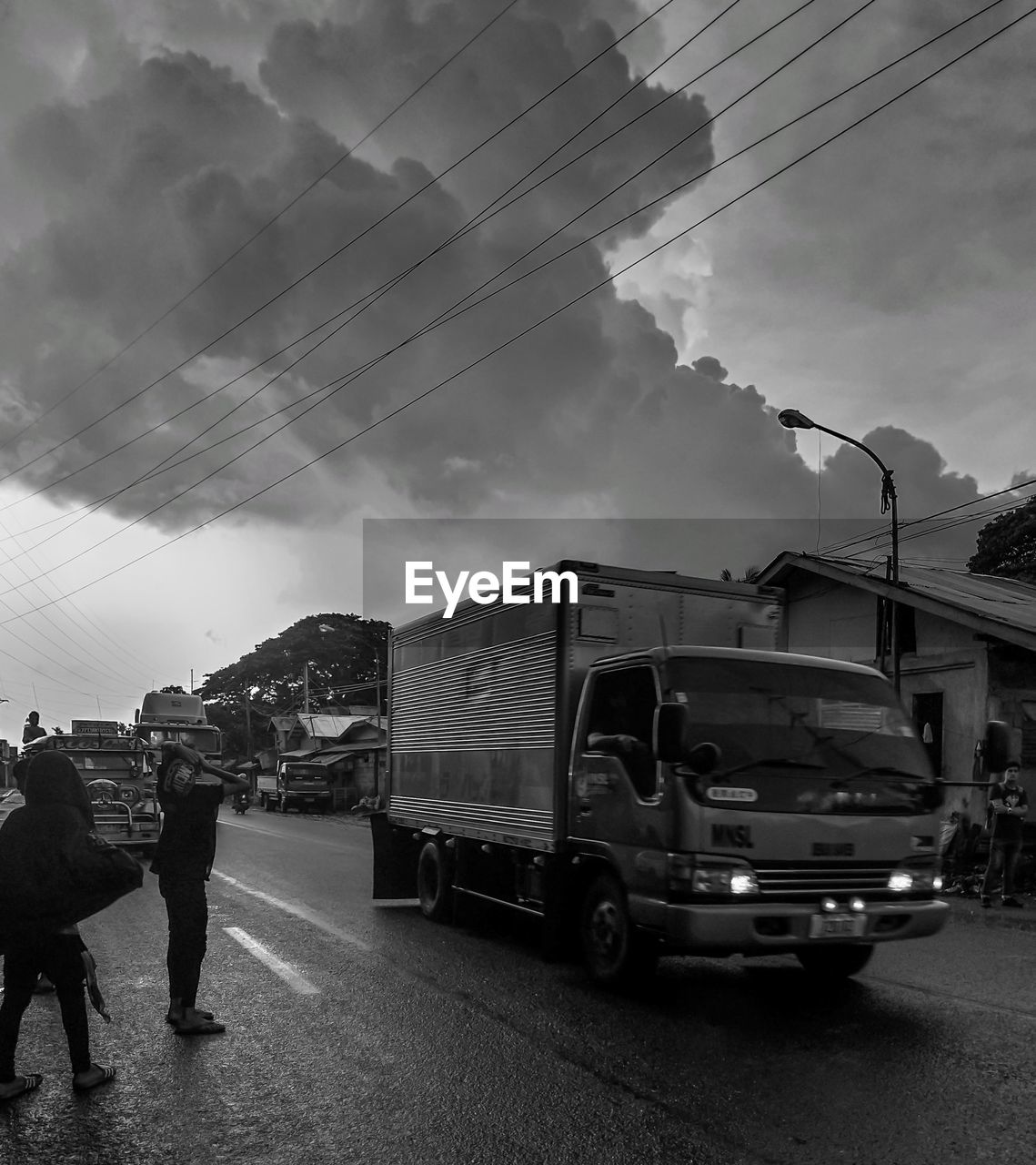 CARS ON STREET AGAINST SKY IN CITY