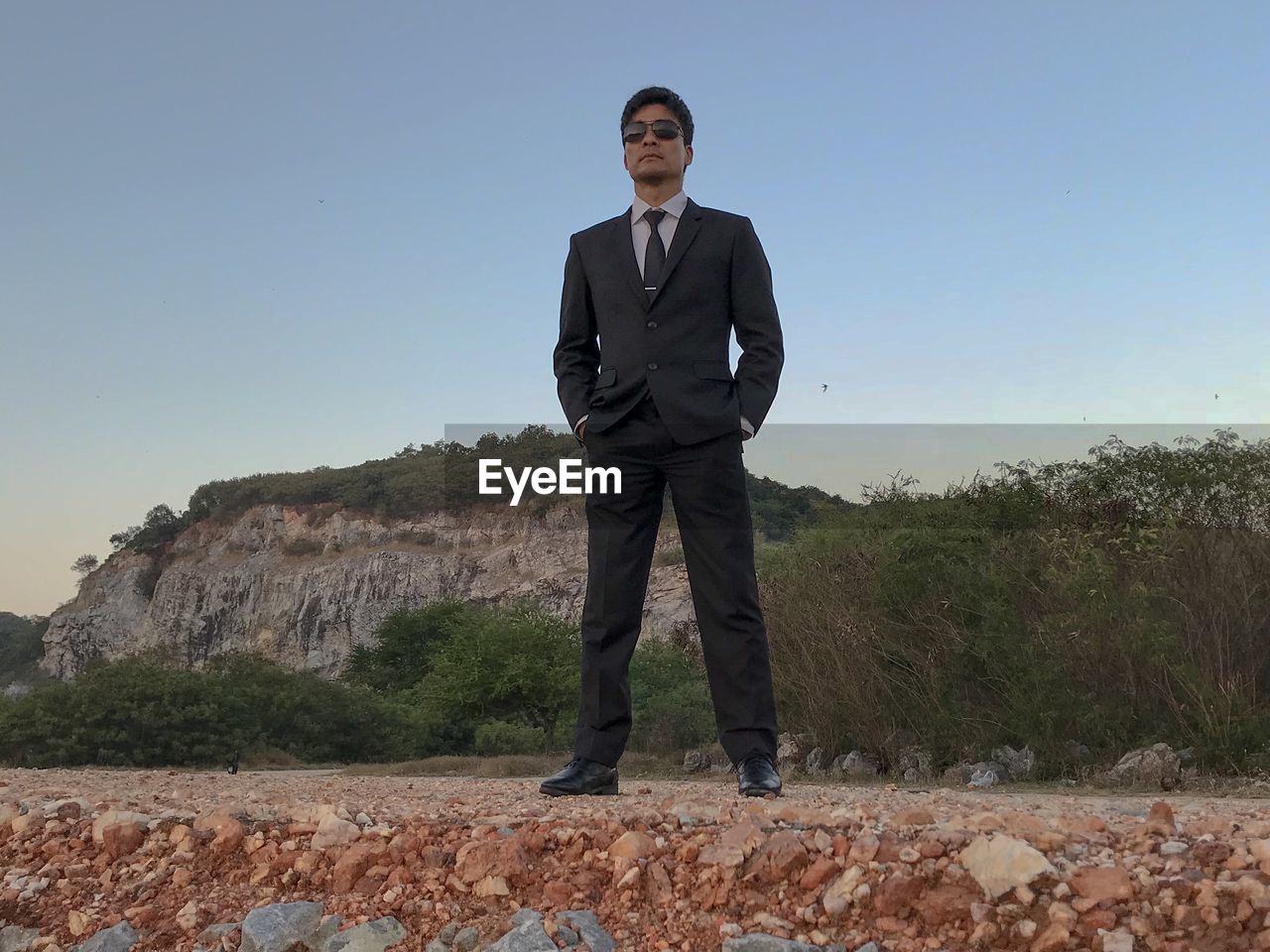 FULL LENGTH PORTRAIT OF YOUNG MAN STANDING ON LAND