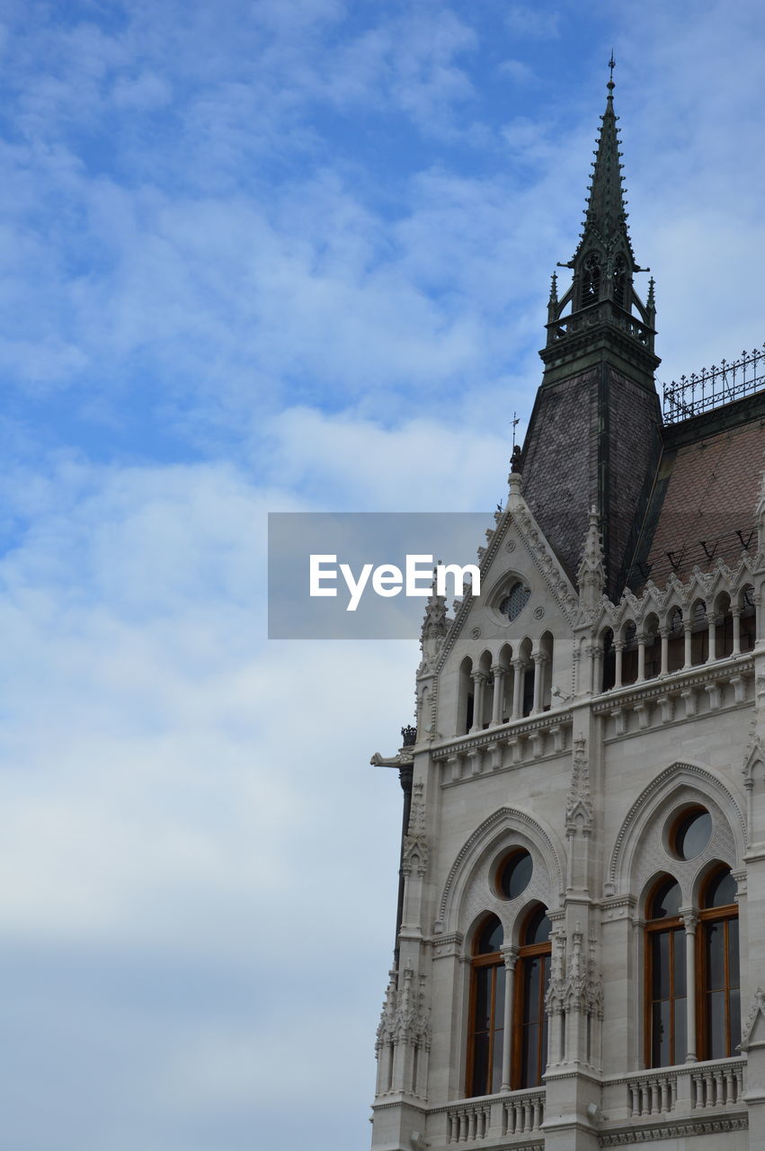 Low angle view of church against cloudy sky