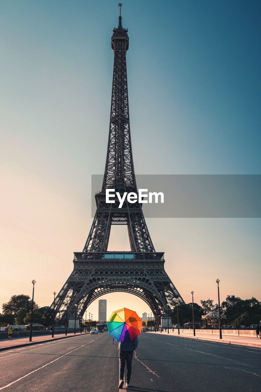 Eiffel tower against clear sky in city during sunset