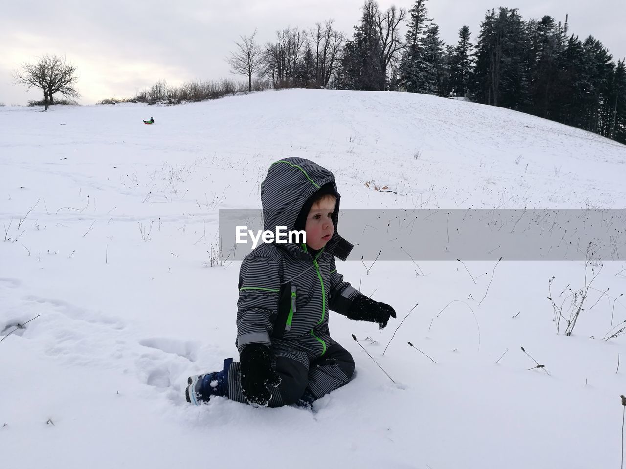 Boy playing on snow field