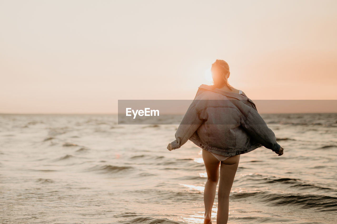 Rear view of woman at beach