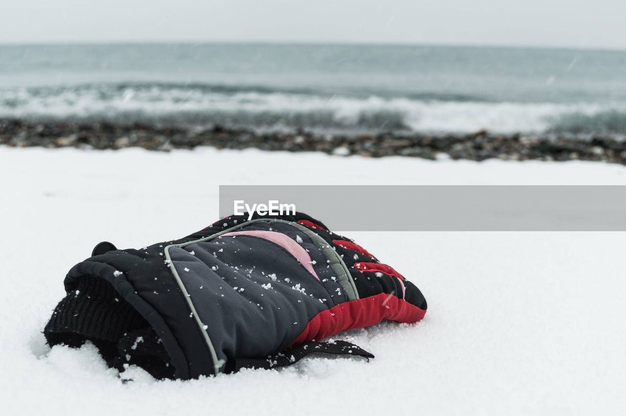 Glove lost on an snowy beach
