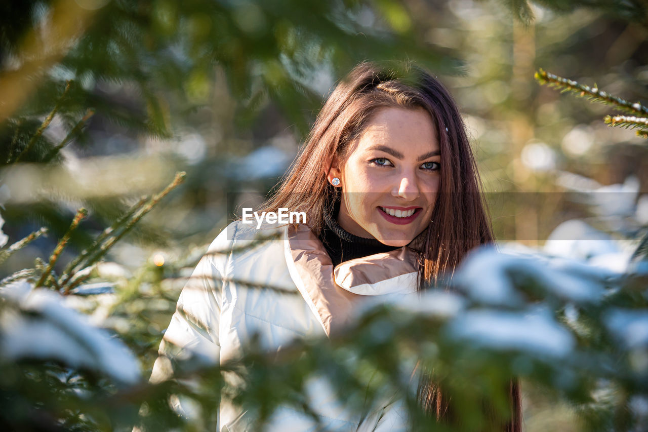 Portrait of a smiling young woman outdoors