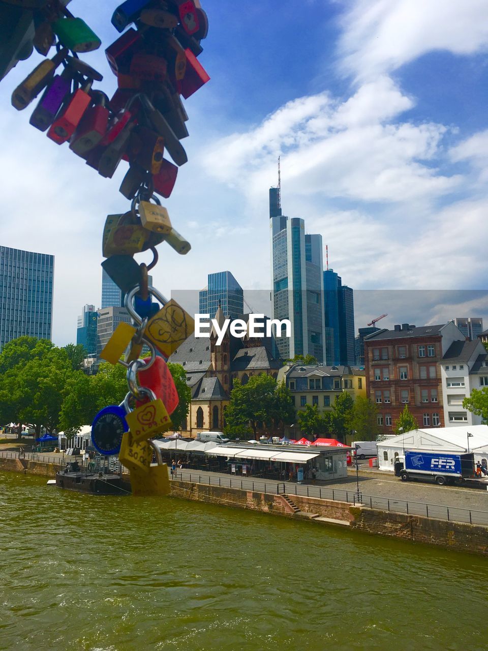 RIVER BY BUILDINGS AGAINST SKY