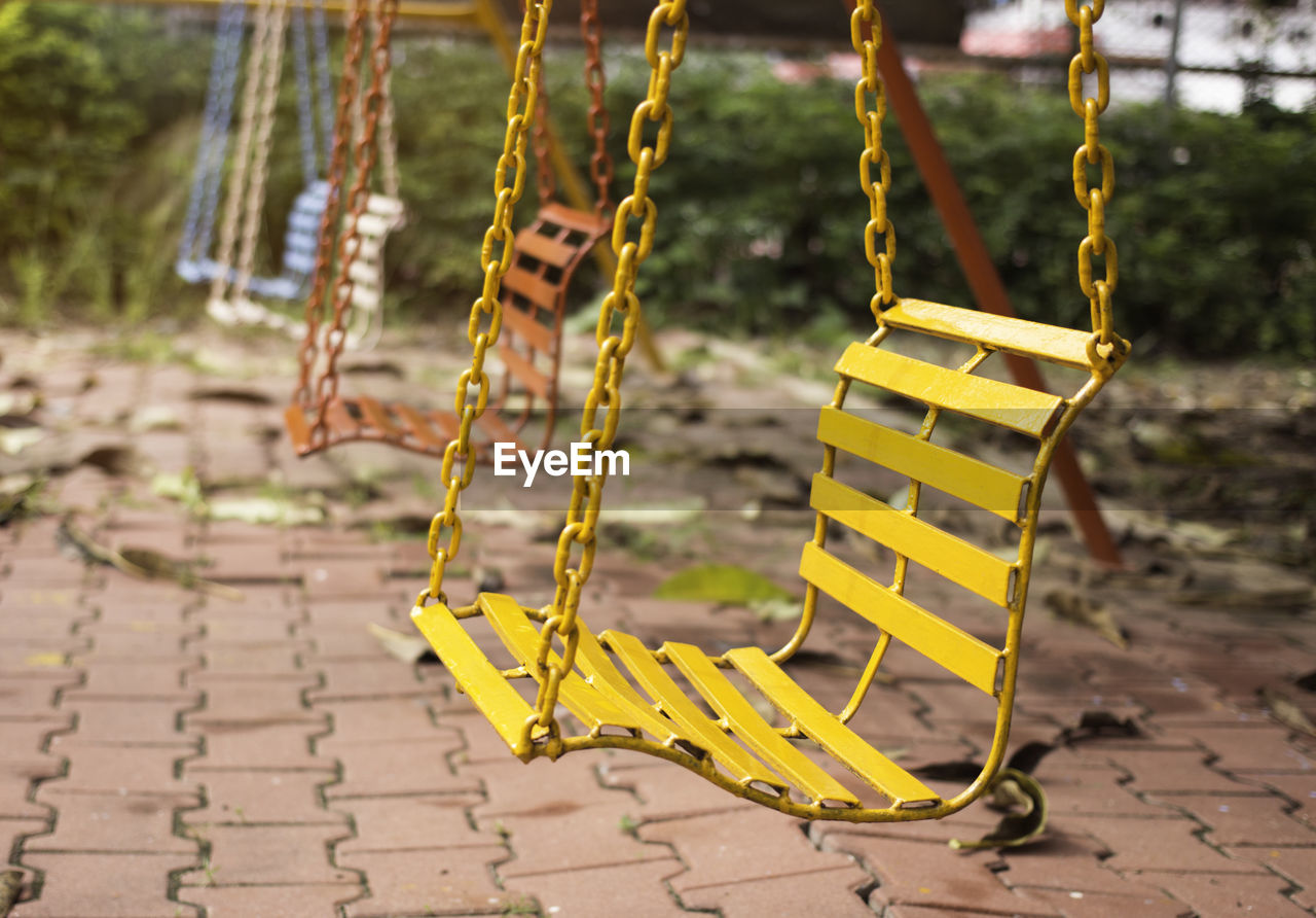 CLOSE-UP OF YELLOW SWING