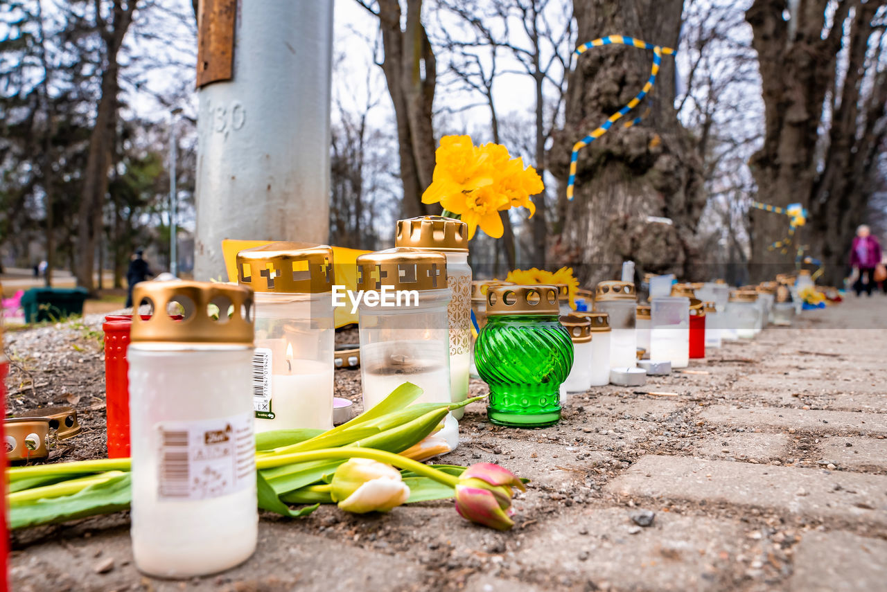 Thousands candles and flowers standing on the street during the war in ukraine