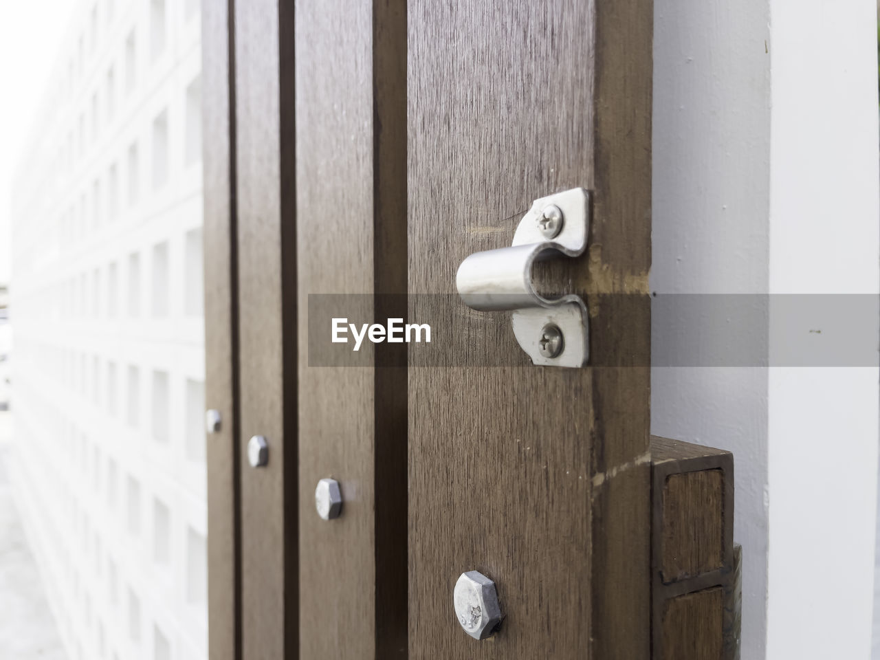 security, door, protection, entrance, lock, closed, wood, door handle, doorknob, knob, furniture, white, keyhole, no people, handle, metal, architecture, close-up, day, building, wall, built structure, room, outdoors, doorway, privacy, building exterior, locker, padlock, security system