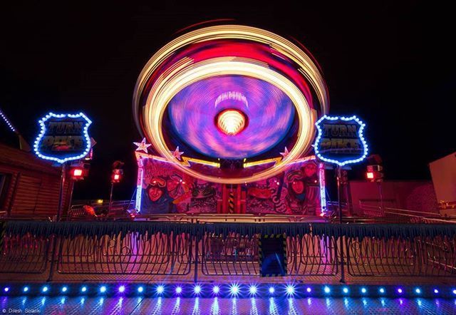 LOW ANGLE VIEW OF ILLUMINATED LIGHTS IN DARK