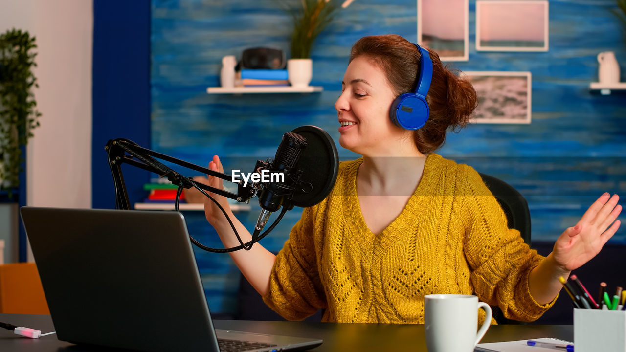 Woman singing at recording studio