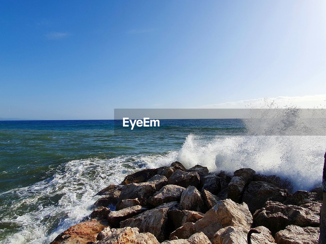 Scenic view of sea against clear blue sky