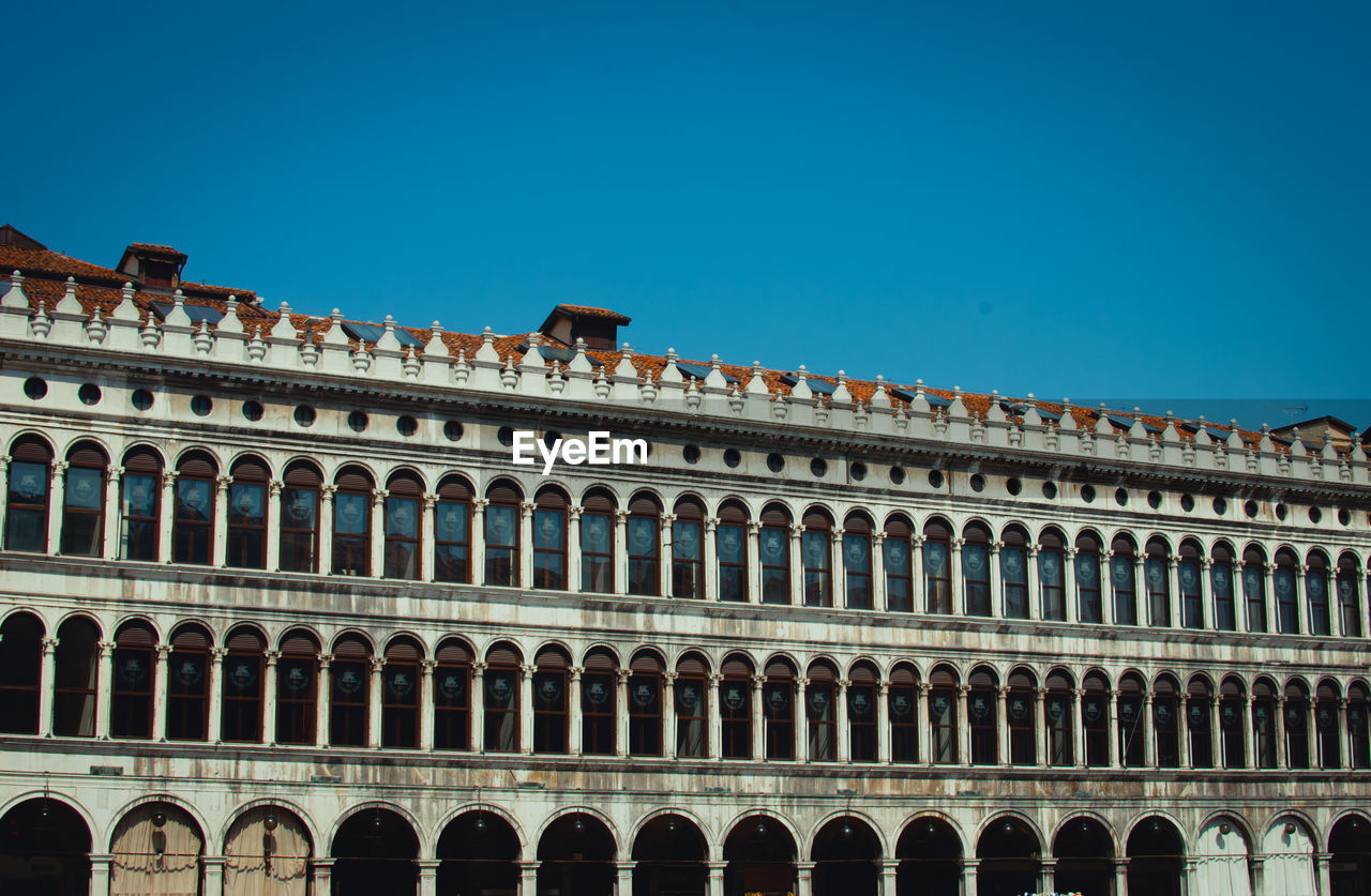 Low angle view of historical building against blue sky