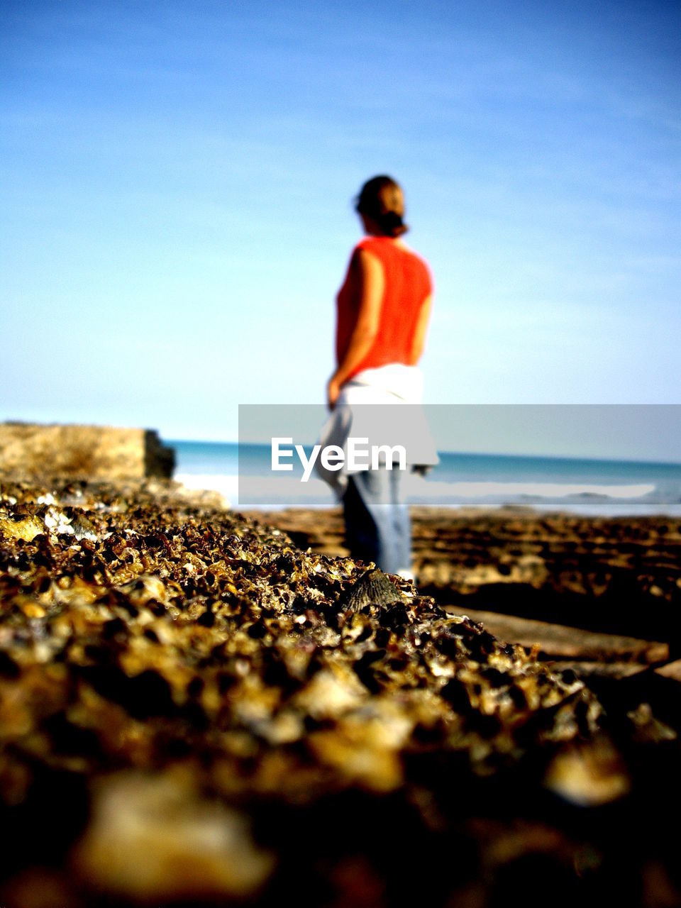 Rear view of woman standing against clear sky