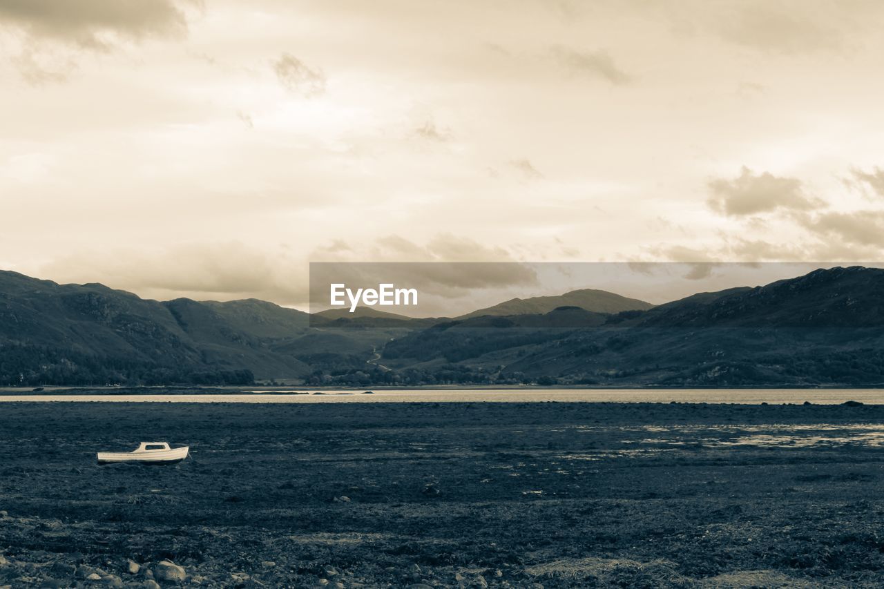 Boat in lake against mountains