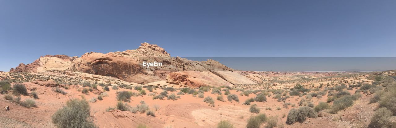 Panoramic view of rocky mountains against clear sky