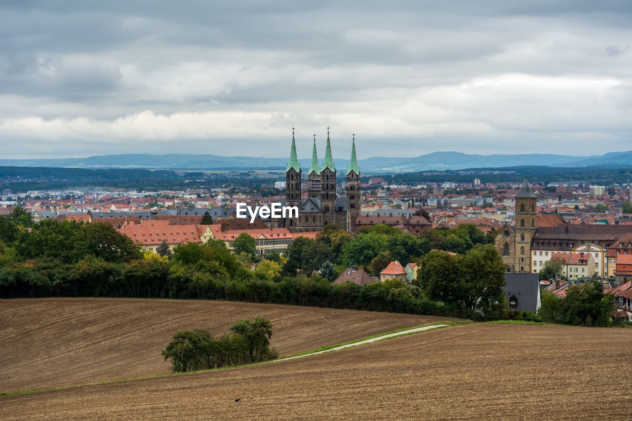 View of town against cloudy sky