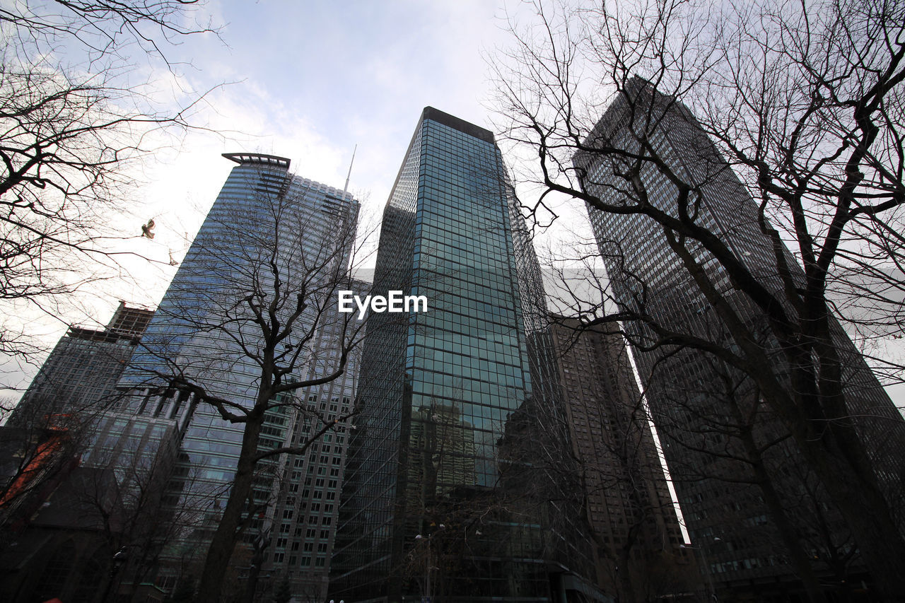 Low angle view of buildings against cloudy sky
