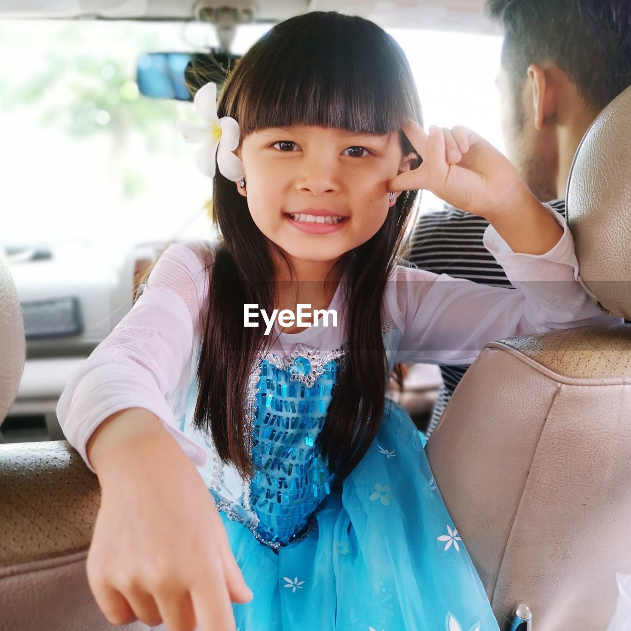 Portrait of cute smiling girl sitting in car