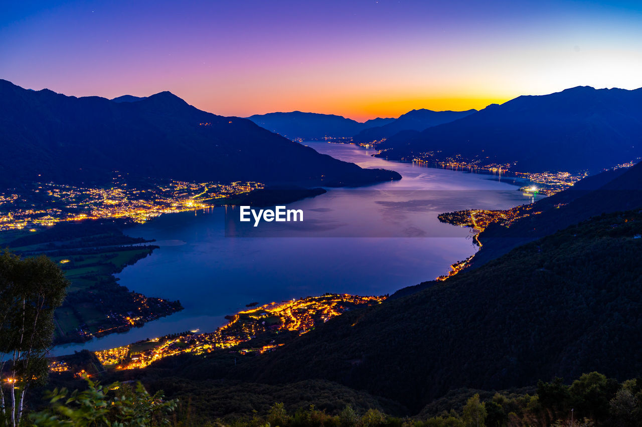 Lake como, photographed by gera lario, in the evening. view of towns and the upper lake mountains.