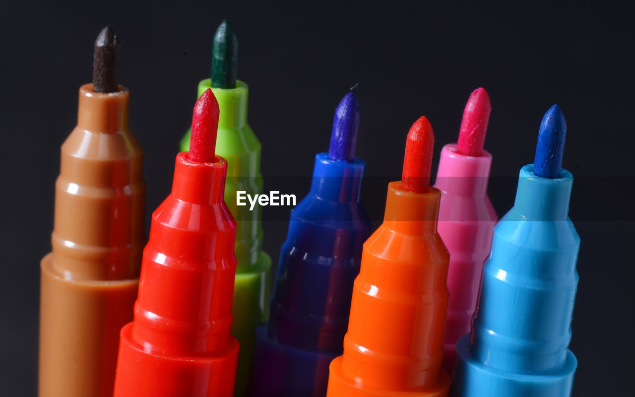 CLOSE-UP OF MULTI COLORED PENCILS IN GLASS