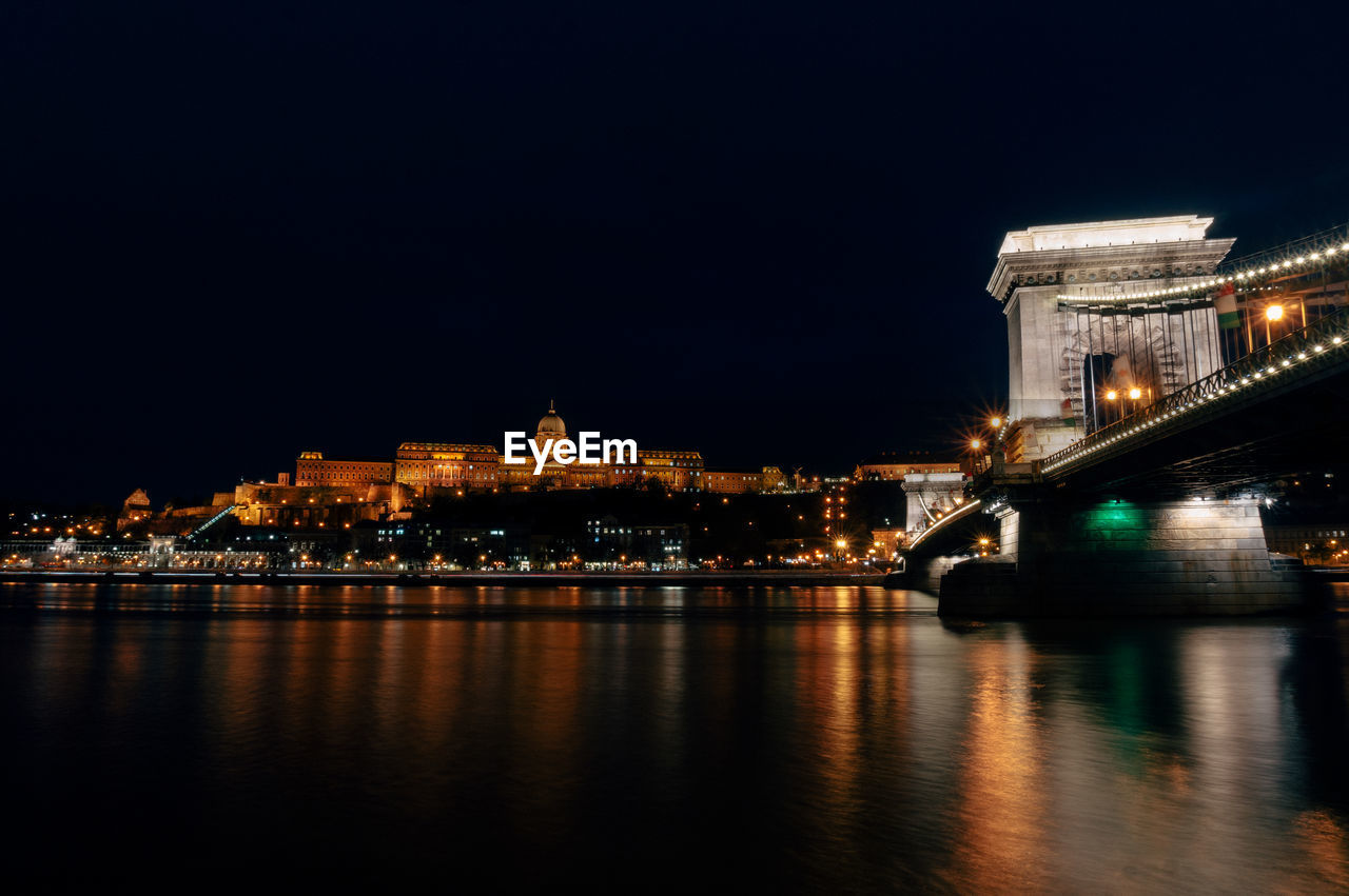 ILLUMINATED BRIDGE OVER RIVER