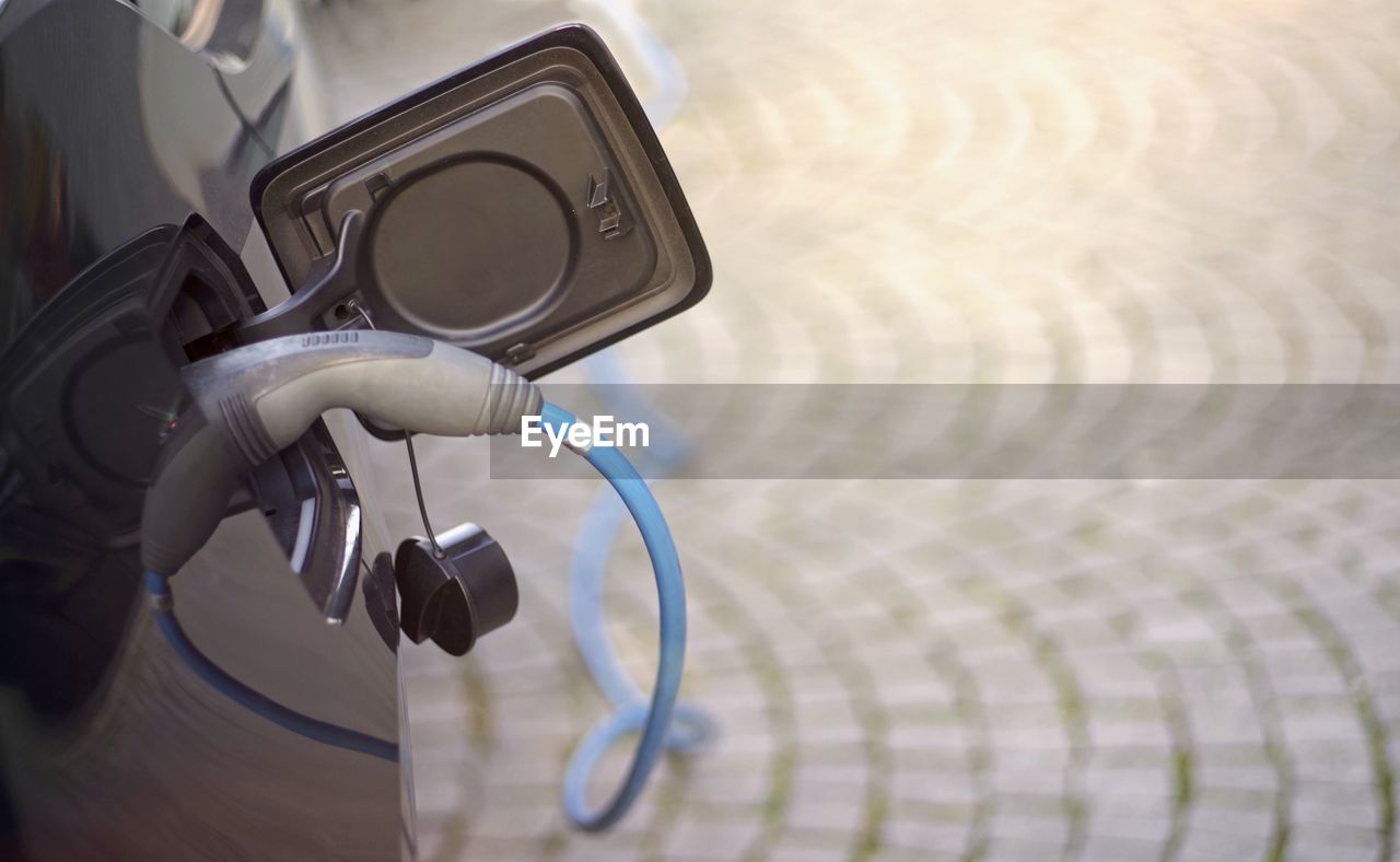 Close-up of car with electric charger