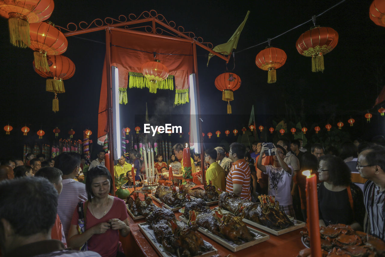 CROWD AT ILLUMINATED MARKET