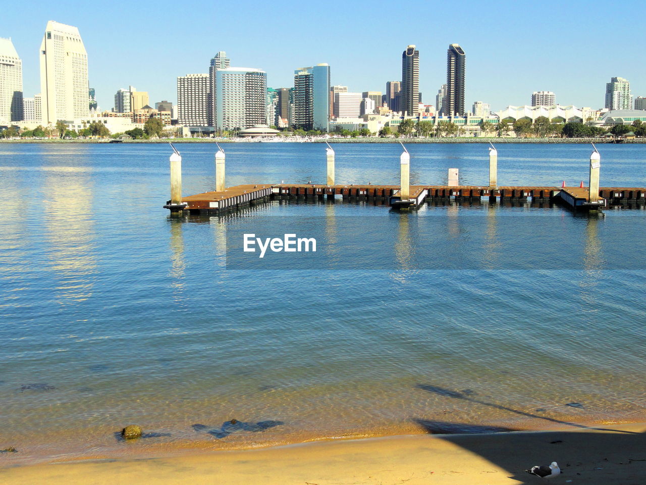 Pier over sea against buildings in city