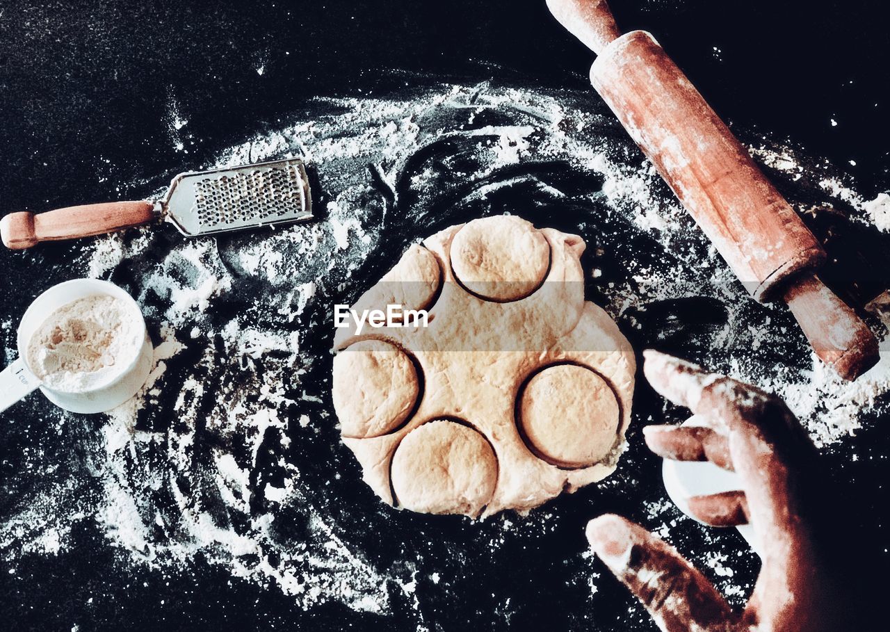 Cropped hand of person preparing dough