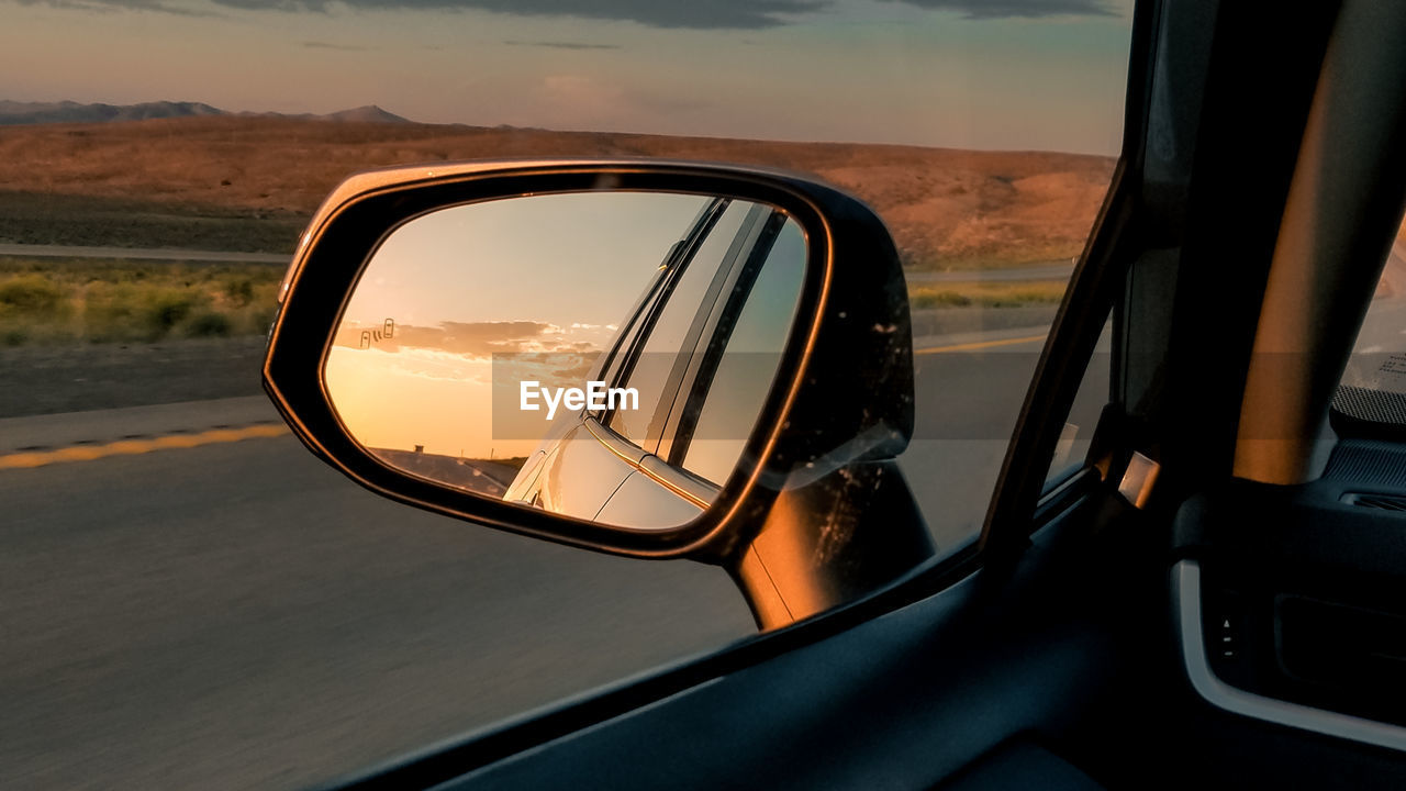 Reflection of car on side-view mirror