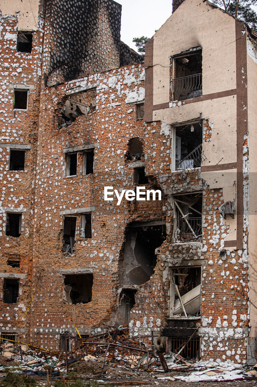 Cities of ukraine after the russian occupation. destroyed buildings on the streets of irpen. 