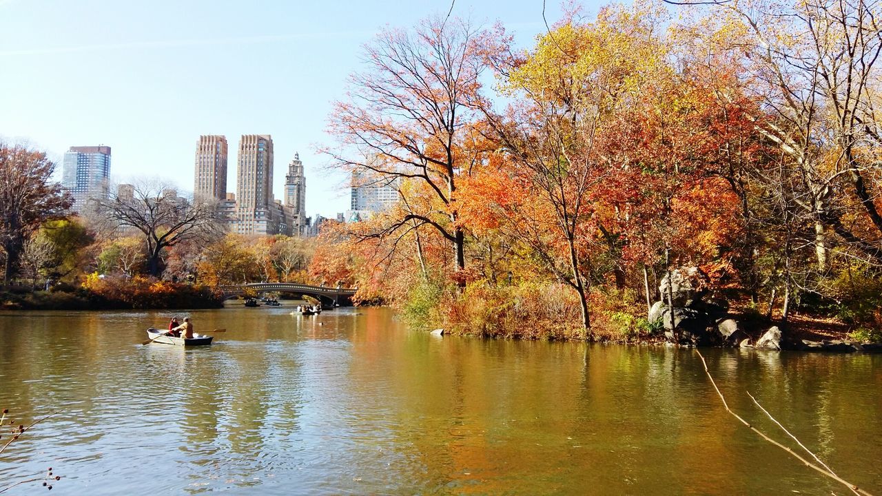 Scenic view of lake by trees against sky