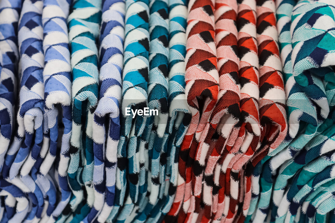 Detailed close up view on samples of cloth and fabrics in different colors found at a fabrics market