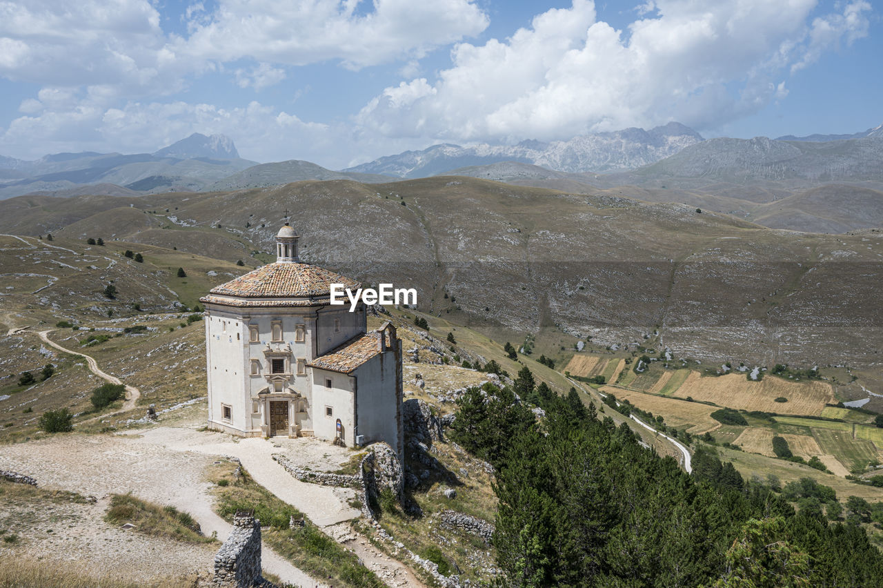 The church of santa maria della pietà in rocca calascio with the beautiful abruzzo mountains 