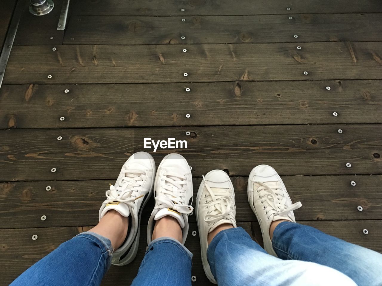 LOW SECTION OF PERSON STANDING ON WOOD