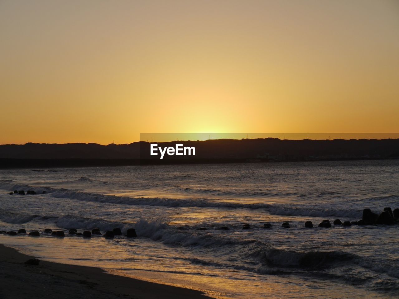 Waves on shore at dusk