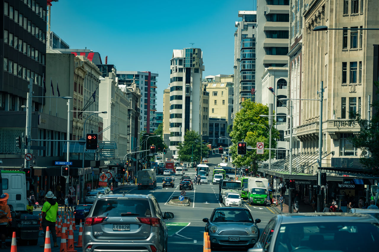 TRAFFIC ON CITY STREET AMIDST BUILDINGS